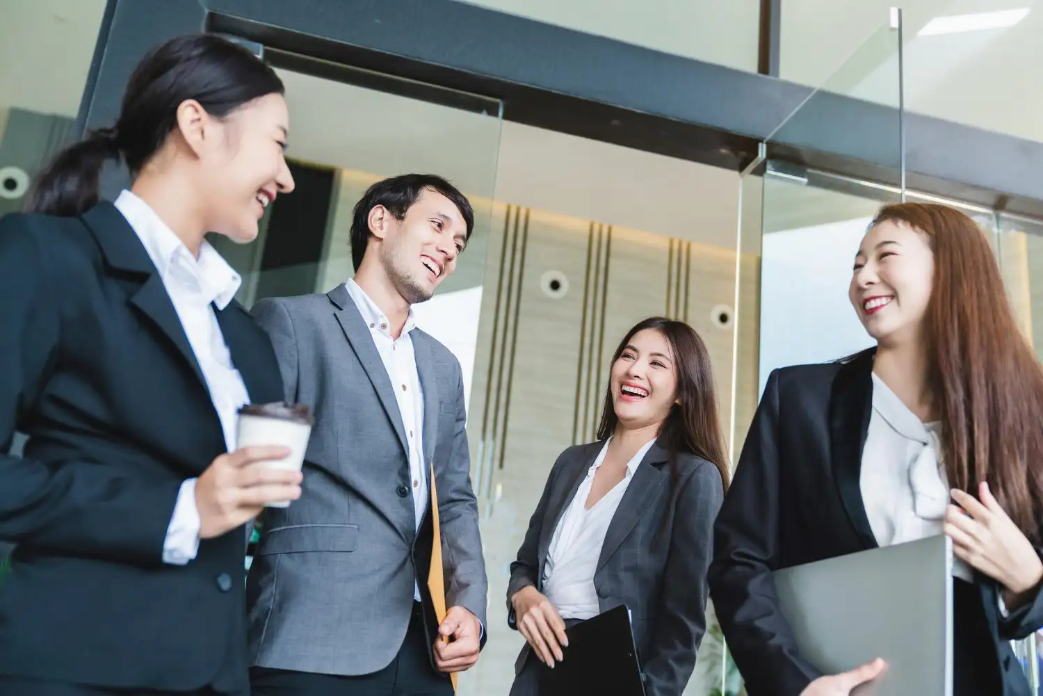 Colleagues walking together through a modern office