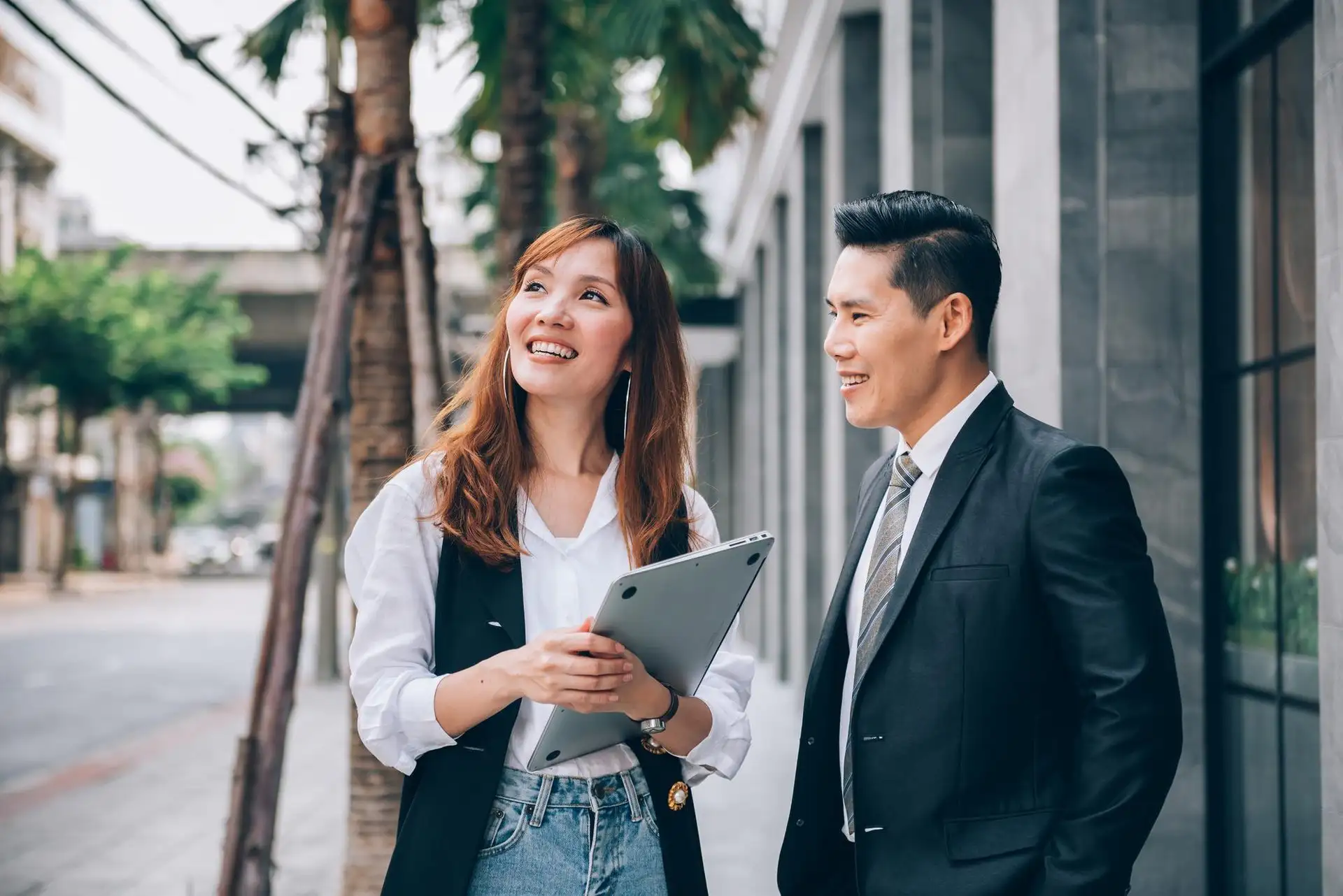 Two professionals in discussion while walking outdoors