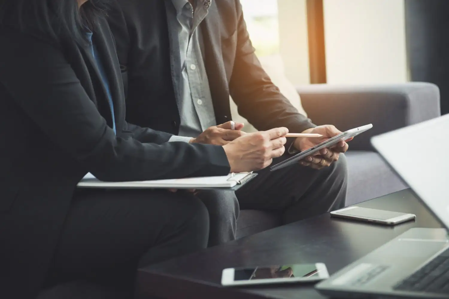 Two advisors reviewing documentation together in a meeting room